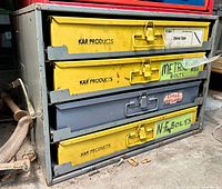 Front view of cabinet showing four drawers labeled Shrink Tube, Metric Bolts, Large Washers, N-F Bolts