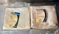 Two brand new welding blankets sealed in plastic packaging, one 4'x6' and one 6'x8', with visible product labels.