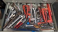 Drawer overview showing assortment of adjustable wrenches, pipe wrenches and pliers