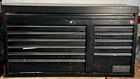 Front view of black Craftsman tool chest showing drawer configuration and logo badge