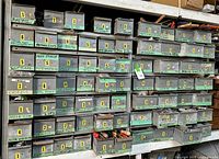 Full metal cabinet on shelving showing multiple rows of small labeled drawers