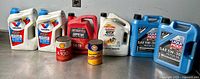 Group of all eight containers: two Valvoline, one Motomaster, one Castrol, two Liqui Moly, one Shell, one Gulf