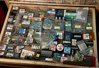 Wide view of the drawer showing a large collection of screws, fasteners, and packaging.