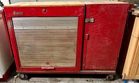 Full front view of red Snap-On tool chest with side cabinet on wheeled dolly