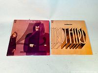 Photo showing both vinyl LP album covers: "Fourth" on left with band members photo and "Third" on right with stylized title