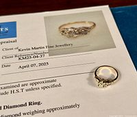 Ring and appraisal certificate, showing ring design and appraisal header.