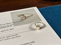 Ring resting on appraisal document showing photo of ring and document header