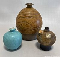 Front view of all three pottery pieces arranged together on a white background, showing size and color contrast.