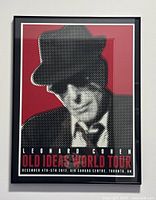 Framed poster showing Leonard Cohen in hat and tie against a red background, with text for Old Ideas World Tour concert December 4-5, 2012, Toronto.