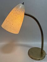 Lamp lit showing the fiberglass lampshade's crackled texture and warm glow.