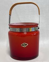 Front view of the red glass ice bucket showing overall condition and color.