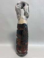 Front view of signed Brutalist pottery art vase, showing full height and textured surface with layered colors and glazes.