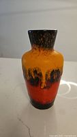 Front and side view of the vintage West German MCM ceramic vase showing lava glaze colors of yellow, orange, and brown.