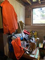 Overall lot with jackets and gear on table