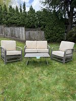 Front view of the full four-piece patio set placed on grass