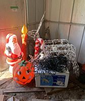 Full lot showing all items including Santa, pumpkin, candle, reindeer, candy cane, and box of lights, with details visible for identification