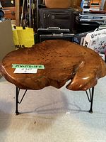 Photo of vintage live edge wood coffee table showing natural wood grain and irregular wooden top with hairpin legs