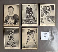 Top side of 5 vintage 1939-40 O-P-C hockey cards featuring players Nick Metz, Les Cunningham, Don Deacon, Joffre Desilets, and Mush March arranged on surface.