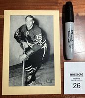 Front photo of vintage Bobby Hull hockey photograph with Sharpie marker for scale and MaxSold lot tag.