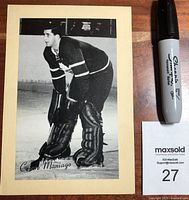 Front view of the black and white hockey photo mounted on a cream matte, showing Cesare Maniago in goalie pose.