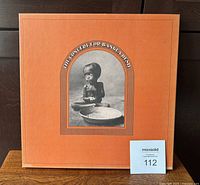Outer box of the 1971 The Concert for Bangladesh 3-LP box set orange cover with photo of child and bowl