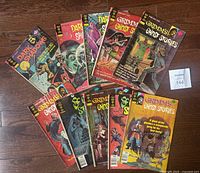 Lot of 10 Gold Key comic books spread out, showing covers of both Grimm's Ghost Stories and Dark Shadows series.