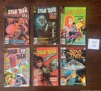Lot of 6 vintage Star Trek comics from 1975 to 1980, showing front covers arranged in two rows on wooden floor.