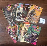 Lot of 10 Gold Key Boris Karloff Tales of Mystery comic books arranged in two rows on a wooden floor, showing colorful vintage horror-themed covers.