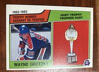 Front image of 1983-84 OPC Hockey card #203 showing Wayne Gretzky in Edmonton Oilers uniform and Hart Trophy.