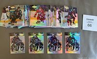 Full view of laid out hockey cards showing a large stack and 4 separate Patrick Roy cards in front.