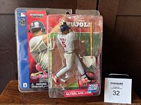 Front view of sealed McFarlane 2002 Albert Pujols rookie action figure in batting stance with packaging showing MLB and Cardinals logos and included bat accessory.