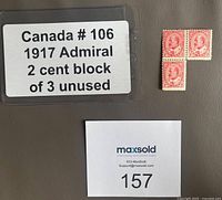 Photo showing a label with lot information and the block of 3 unused Canadian stamps in red featuring an Admiral portrait.