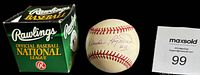 Photo showing the signed baseball positioned between the green Rawlings box and a MaxSold lot card on a black background