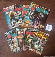 Front view of 10 D.C. "The House of Mystery" comic books, covers showing various horror-themed artwork.