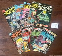 Photo showing all 10 DC Unexpected comic books with various horror-themed covers.