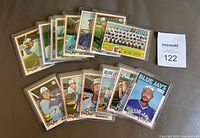14 Toronto Blue Jays baseball cards in hard holders spread out showing front designs.