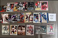Photo showing multiple rows of signed NHL hockey cards, featuring various players and designs, some cards in protective sleeves.