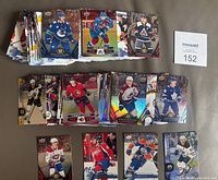 Full overview of spread out hockey cards showing multiple players from various teams with different card designs and styles.