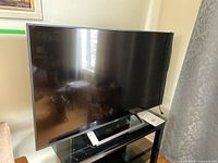 Front view of Sony Bravia 55-inch LED TV on stand showing screen and bezel.