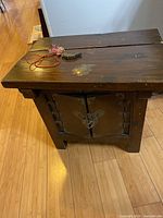 Top-side view of the cabinet showing the flat top surface and partial front doors with some wear.