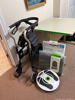 Walker, Revitive circulation booster, original box, and carry bag displayed on floor near table