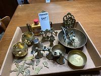 Lot of mixed brass items including two angel candleholders, two bowls, brass letter/book holder, decorative pieces and picture easel.