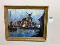 Full view of framed oil painting showing windmill on water, boats docked, and surrounding buildings.
