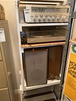 Overall view of Marantz receiver on top shelf, Pioneer turntable below, pair of speakers at bottom