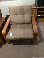 Front view of teak armchair showing frame and cushions