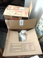 Box containing multiple glass canning jars with some visible packaging and Bernardin branding on the box.