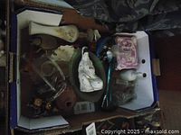 Top view of the box containing multiple small collectible items including figurines, vases, and glassware