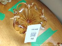 Top view showing the ruffled edge design, amber glass color, and smooth finish. No chips or cracks visible.