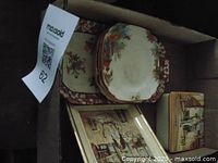 Photo showing trinket box and tray with floral and village scene designs inside a box