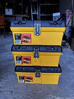 Three stacked yellow and black Workforce 16" Series 2000 toolboxes with metal latches and carry handles.